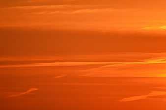 Vibrant Orange Sunset Sky with Streaky Clouds