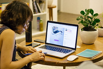 Woman working on laptop in cozy home office