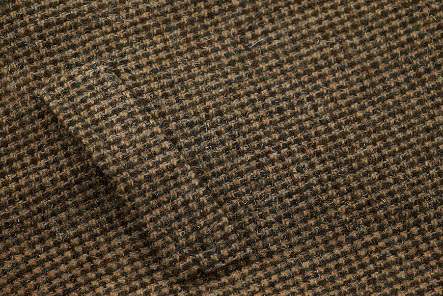 Close-up of brown and black tweed wool fabric texture