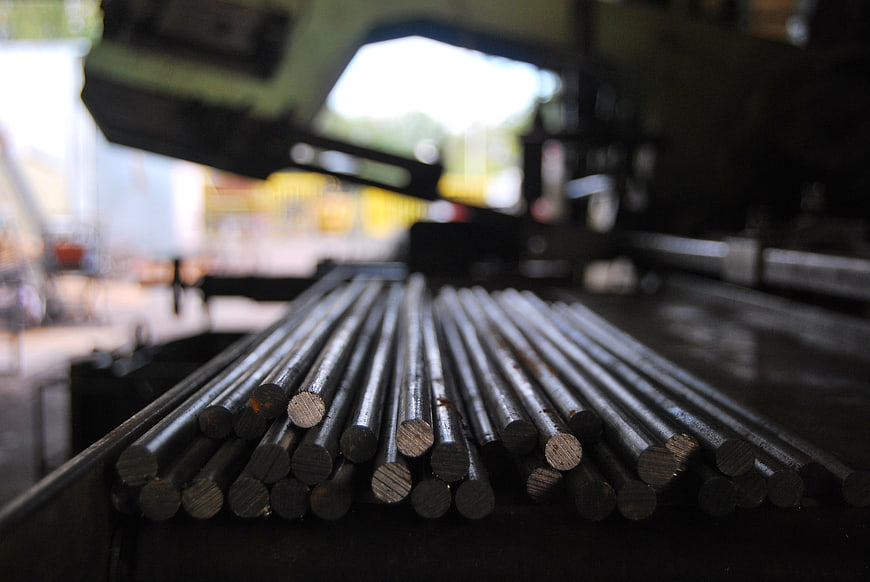 Close-up of steel rods on industrial cutting machine