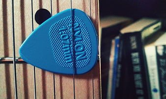 Blue Nylon Guitar Pick on Acoustic Guitar Strings