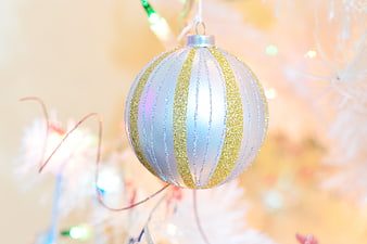 Silver and Gold Glitter Christmas Ornament on White Tree