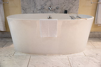 Modern White Freestanding Bathtub in Luxury Marble Bathroom