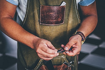 Barista in Apron Holding Coffee Beans