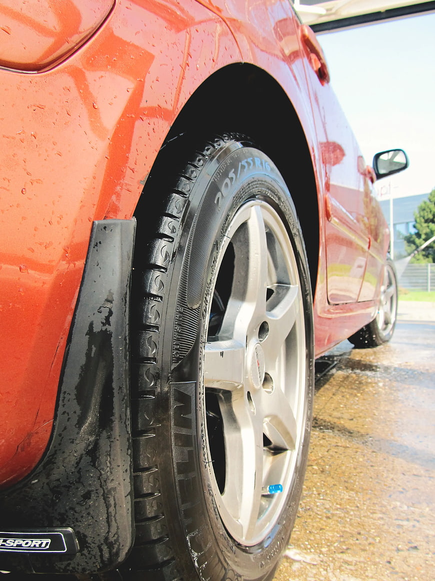 Close-up of Red Car Wheel with Water Droplets