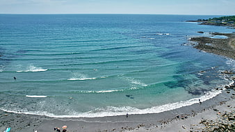 Aerial View of Turquoise Ocean Waves and Rocky Beach