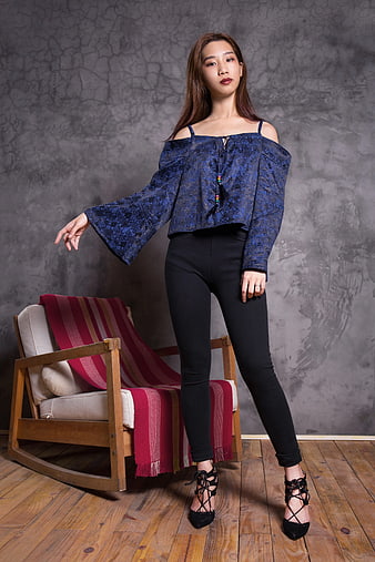 Woman in Blue Off-shoulder Top and Black Pants Standing