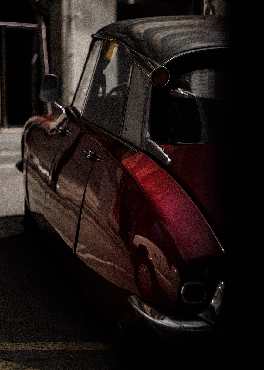 Vintage Red Car Side Profile in Dark Moody Lighting