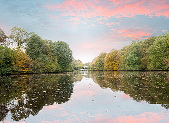 Serene Lake Reflection with Pink Sunset Sky and Autumn Trees