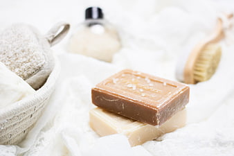Natural Soap Bars and Bath Accessories on White Linen