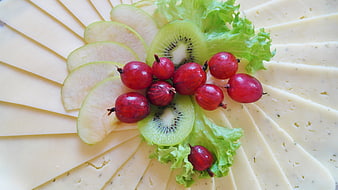 Artistic Cheese Platter With Kiwi, Apple, And Cranberries