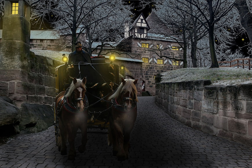 Horse-drawn carriage on cobblestone path at night