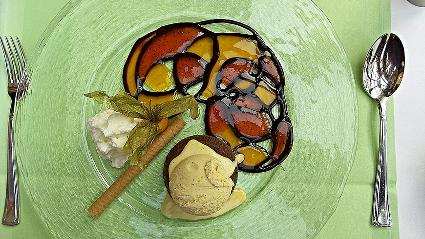 Overhead view of gourmet dessert with caramelized fruit and ice cream