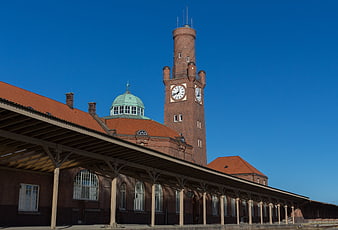 Historic Brick Train Station with Clock Tower and Blue Sky