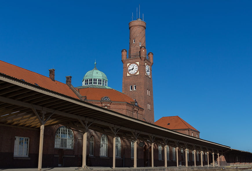 Historic Brick Train Station with Clock Tower and Blue Sky