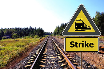Railway Strike Warning Sign Beside Tracks In Rural Landscape