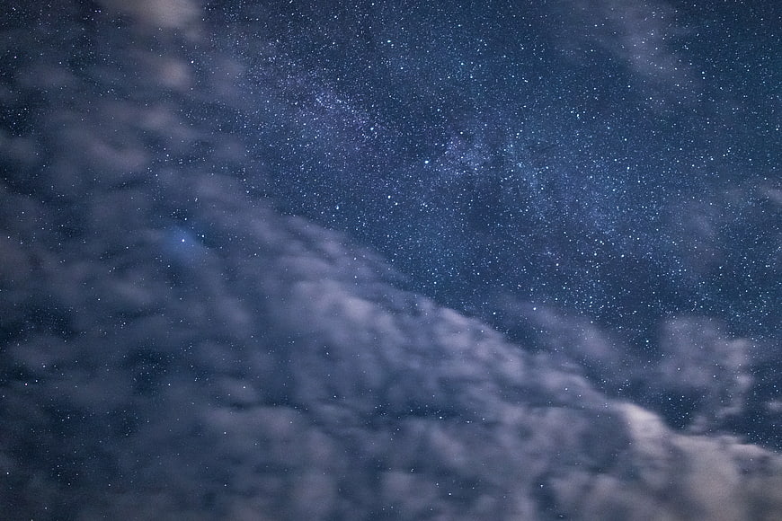 Milky Way Galaxy Through Clouds at Night Sky