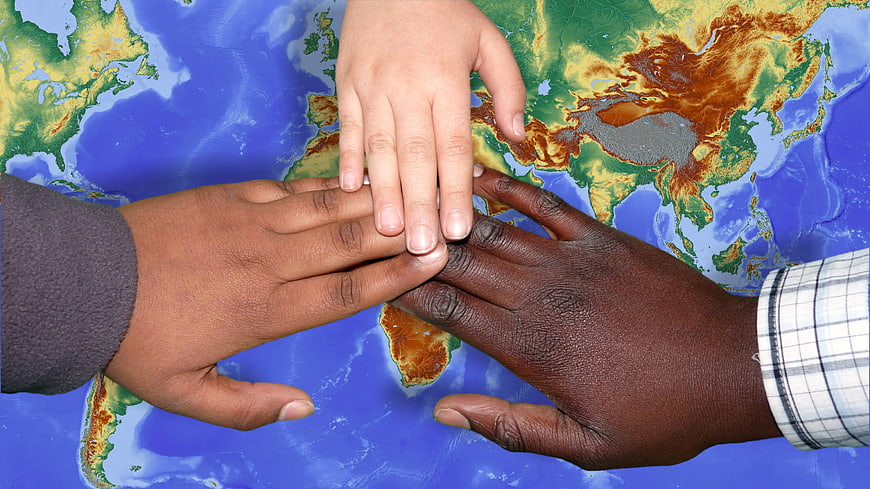 Diverse Hands Stacked on World Map Symbolizing Unity