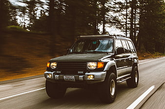 Black SUV Driving Fast on Forest Road