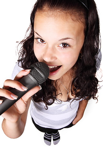 Teen Girl Singing into Microphone from High Angle