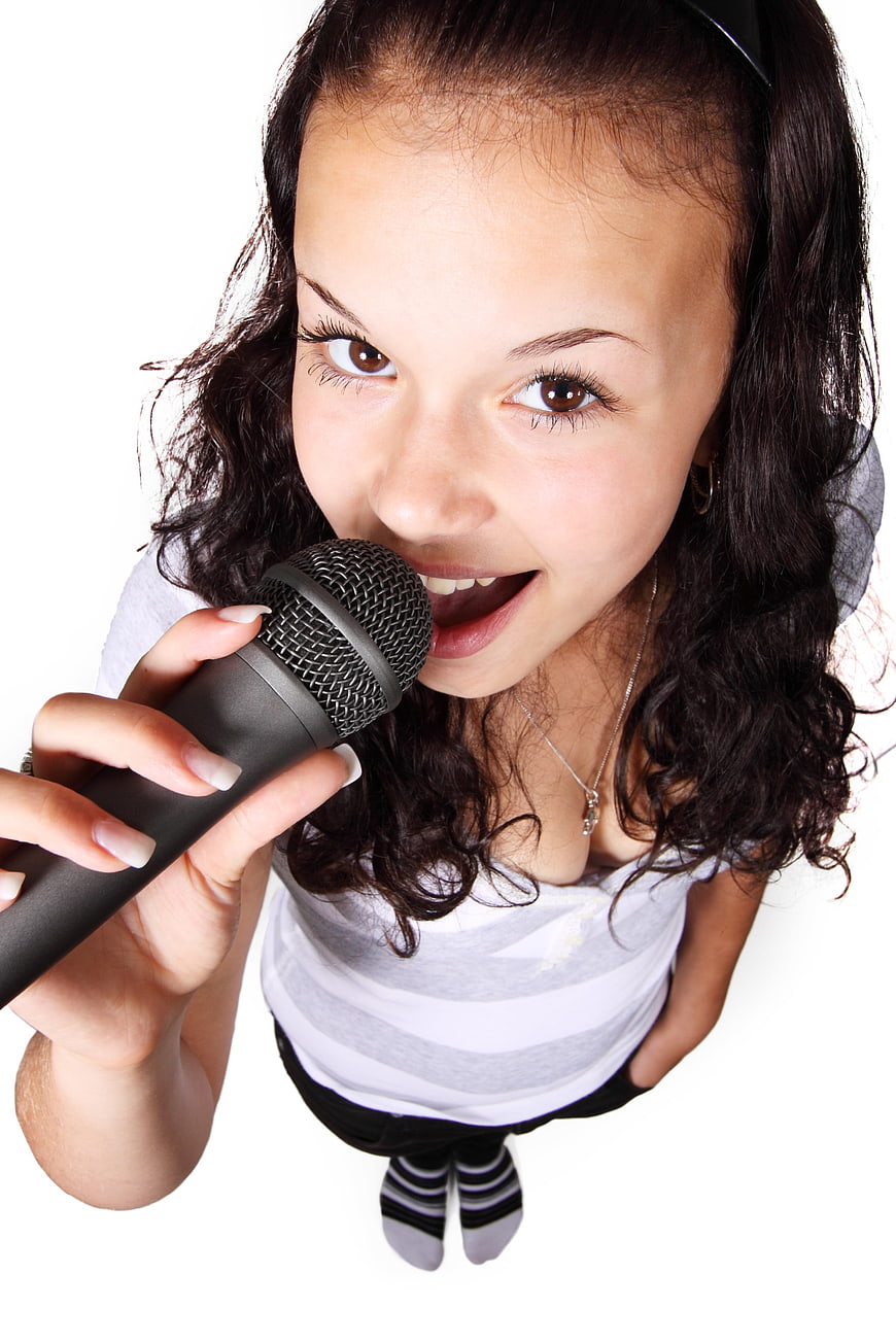 Teen Girl Singing into Microphone from High Angle