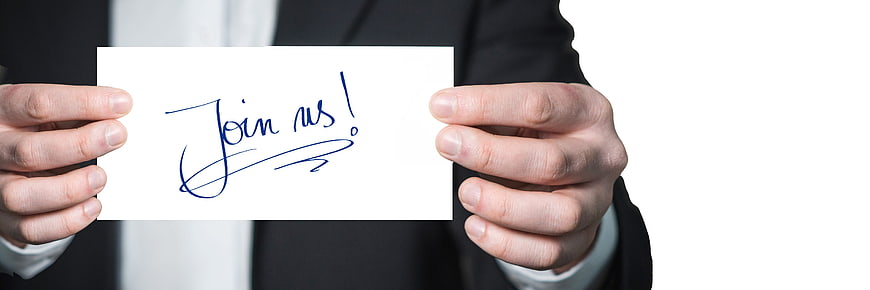 Businessman holding card with handwritten join us invitation