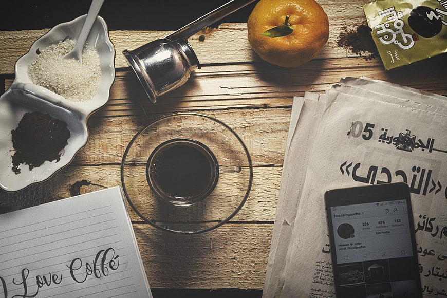 Flat Lay Coffee Cup with Sugar, Orange, and Smartphone