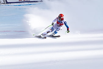 Alpine skier carving a turn during a World Cup downhill race