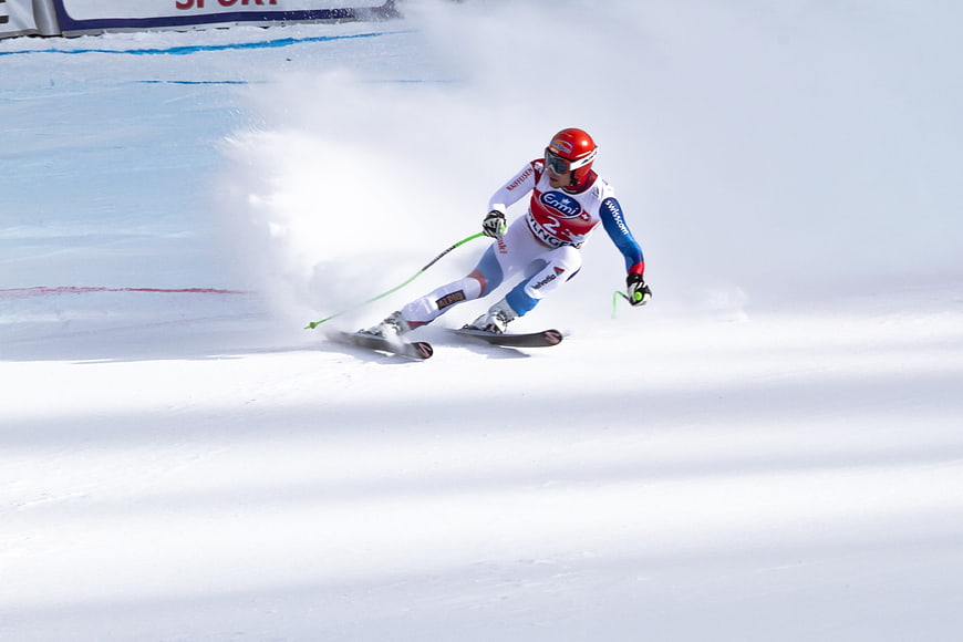 Alpine skier carving a turn during a World Cup downhill race