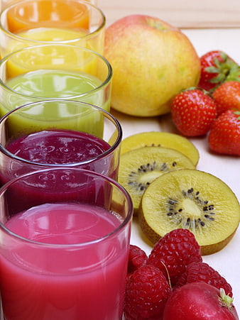 Colorful Fruit Juices in Glasses with Fresh Apples, Strawberries, Kiwi, and Raspberries