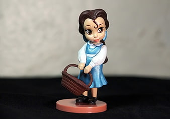 Cinderella figurine holding a basket on a pink base