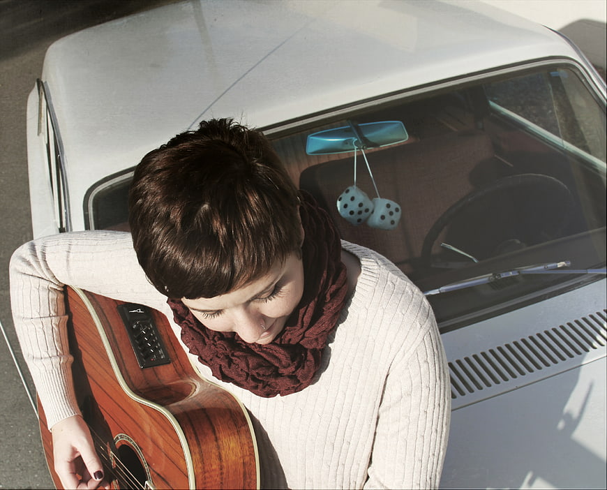 High Angle View of Woman with Guitar by Vintage Car