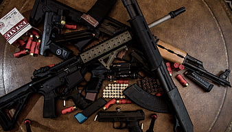 Assorted Firearms And Ammunition Flat Lay On Leather Surface