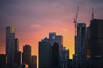City Skyline at Sunset with Construction Crane