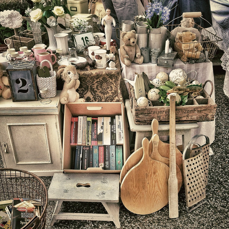 Vintage flea market stall with antiques, books, and decor