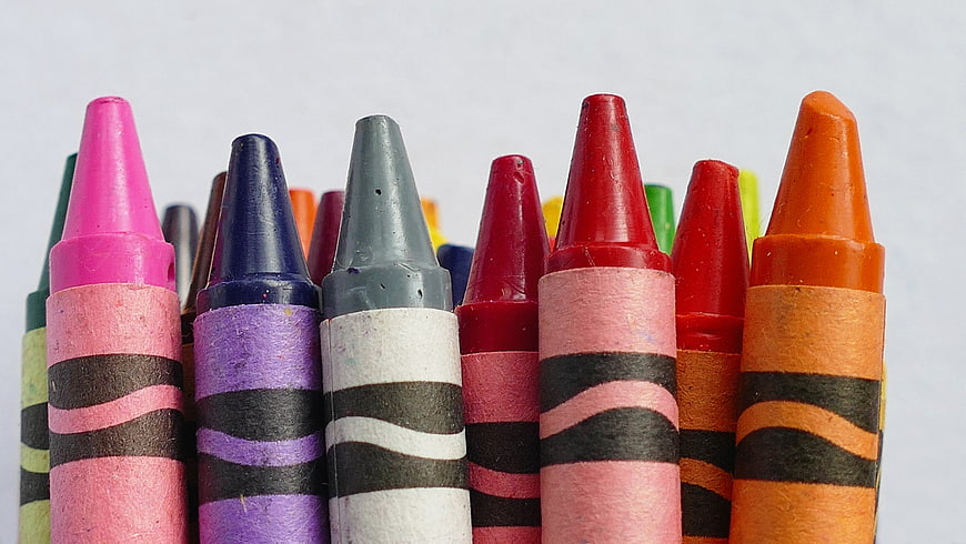 Close-up of colorful wax crayons on white background