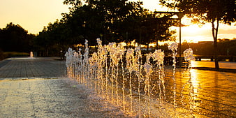 Golden Hour Water Fountain Jets in Urban Park