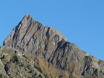 Rugged Rocky Mountain Peak Against Clear Blue Sky