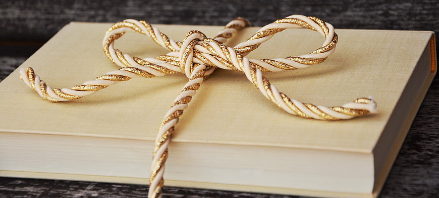 Beige Book Tied with Gold and White Ribbon