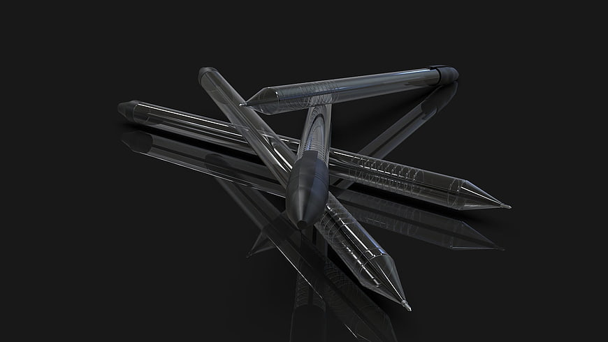 Transparent black pens on reflective dark surface