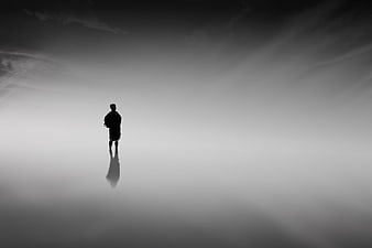 Silhouette of Man Standing in Foggy Minimalist Landscape