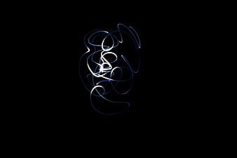 Abstract white and blue light painting swirl on black background