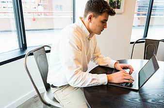 Young man working on laptop in modern office