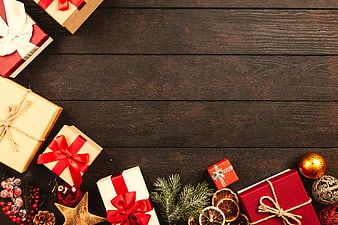 Christmas gifts and decorations on dark wood background