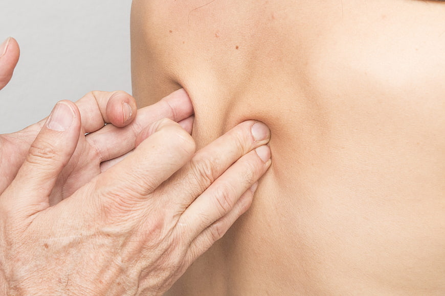 Close-up of hands performing manual therapy massage on back