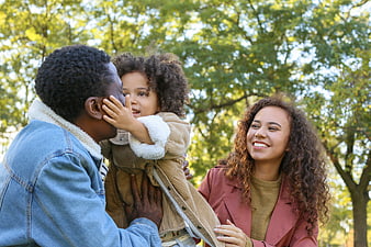 Happy Black Family Playing Together in Park