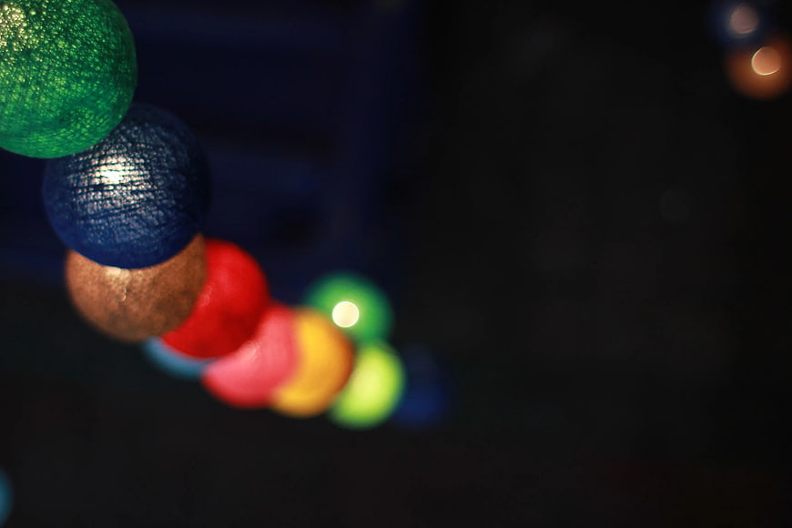 Close-up of colorful wooden beads on a dark background