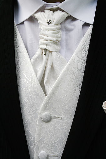 Close-up of white wedding tuxedo vest and cravat