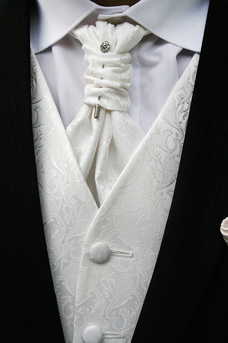 Close-up of white wedding tuxedo vest and cravat