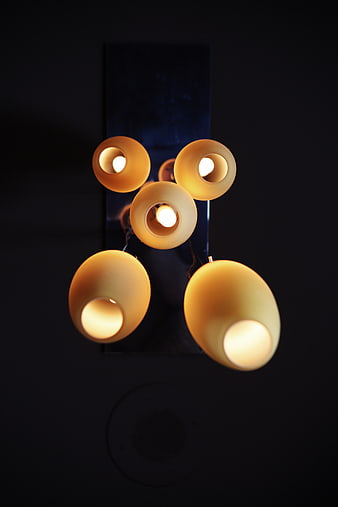 Modern spherical pendant lights hanging in dark interior